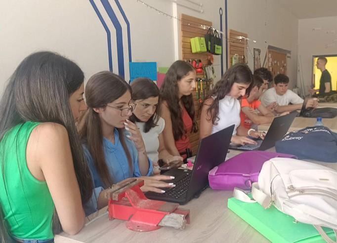 Students working together on laptops during a hands-on workshop
